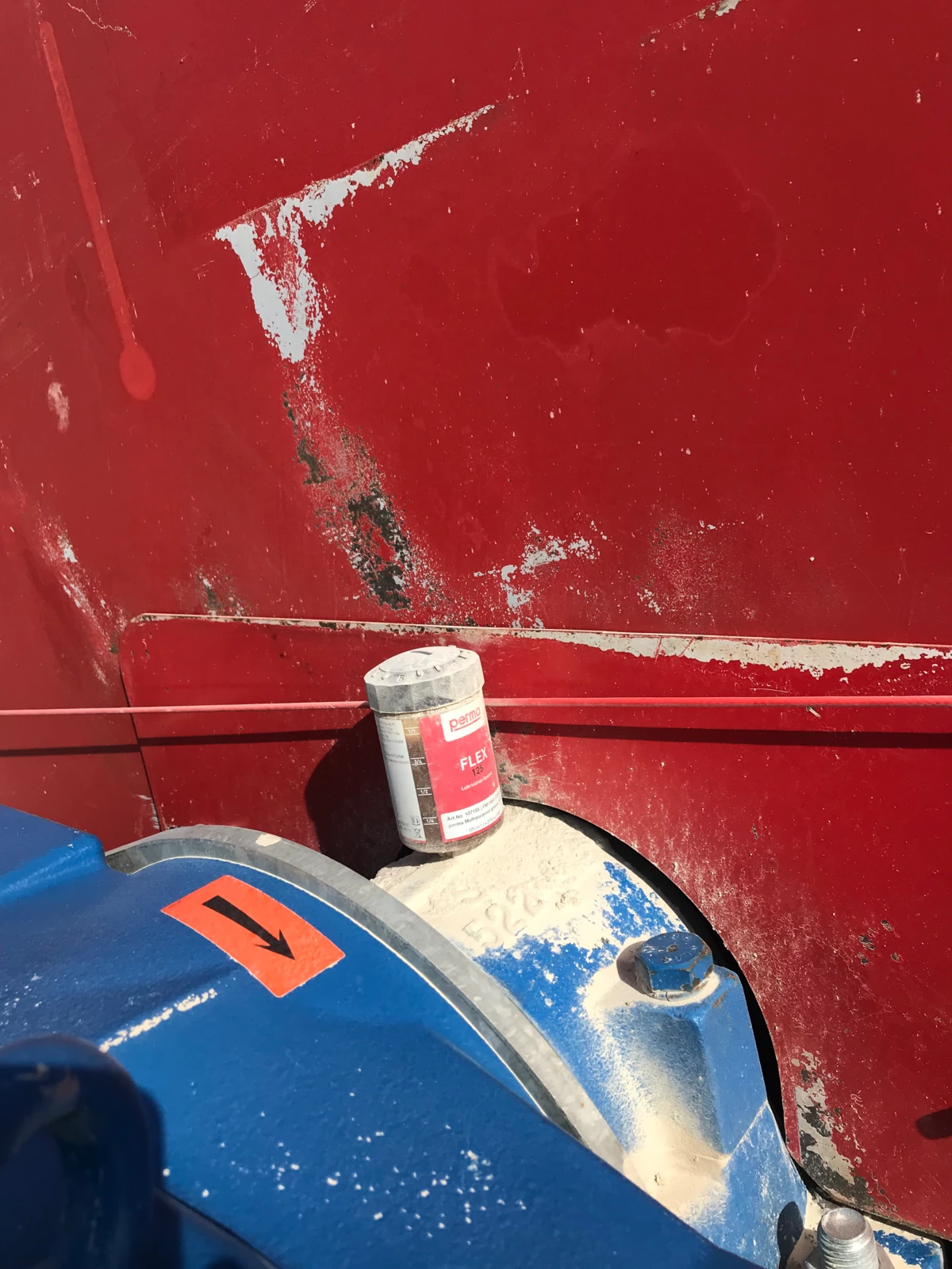 a perma FLEX auto greaser directly mounted onto a lube point