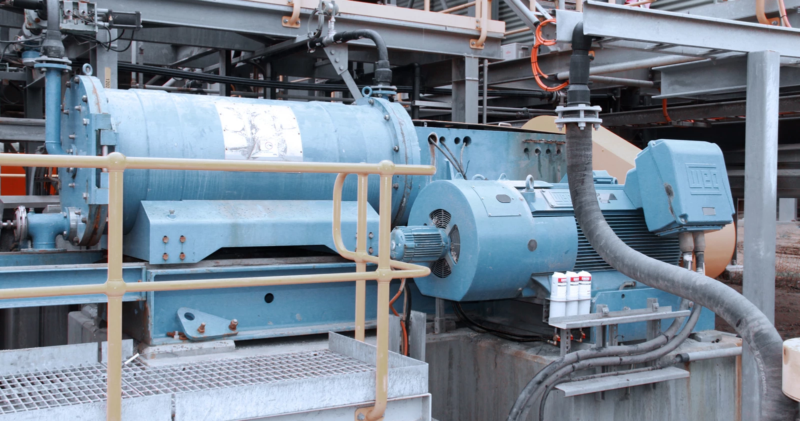 three perma STAR VARIO automatic lubrication solutions mounted on a large piece of industrial machinery
