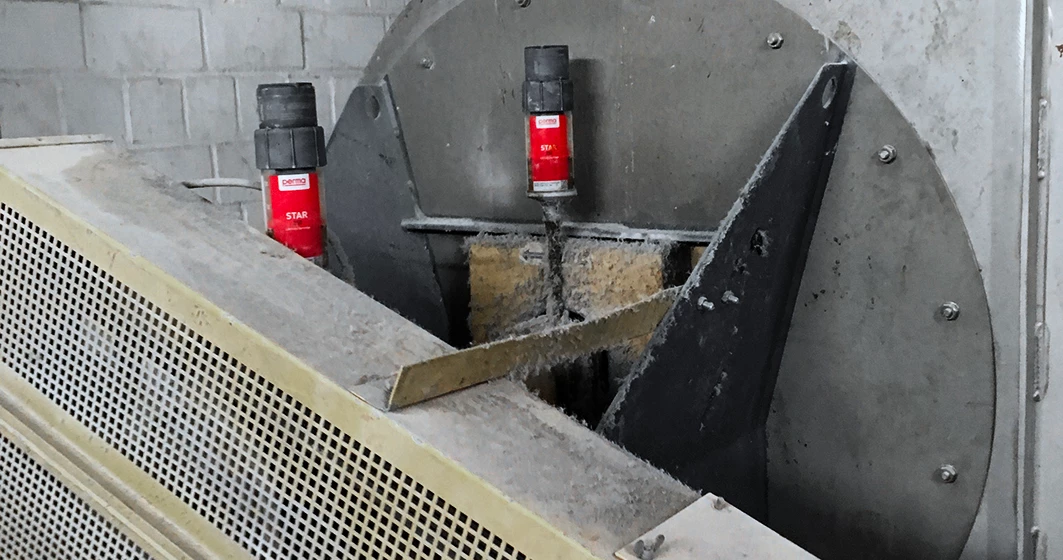two perma auto greaser on industrial equipment