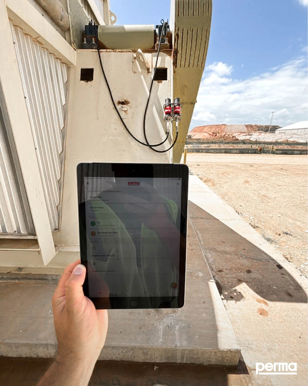 Technician using connected maintenance technology in an industrial facility