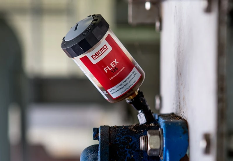a perma FLEX automatic lubricator mounted directly onto a lube point