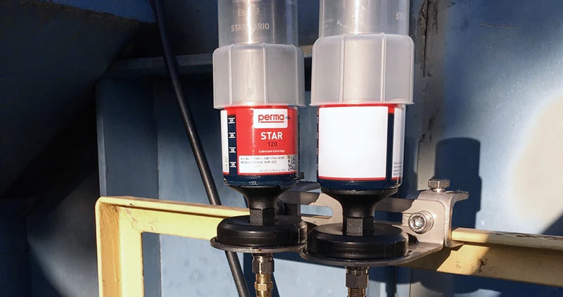 Two auto greasers mounted remotely with hoses