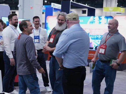 Attendees engage in discussions with the perma USA team at the SMRP 2026 conference exhibit hall.