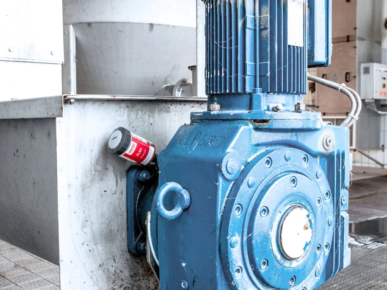 a perma FLEX auto greaser installed on heavy machinery