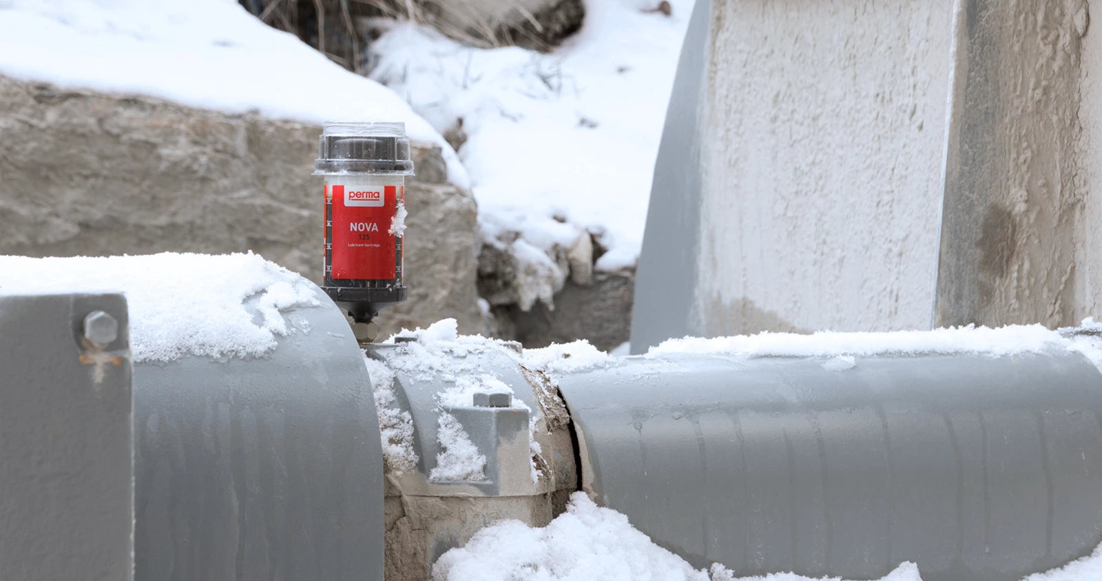 perma FLEX automatic greaser outdoors in the snow