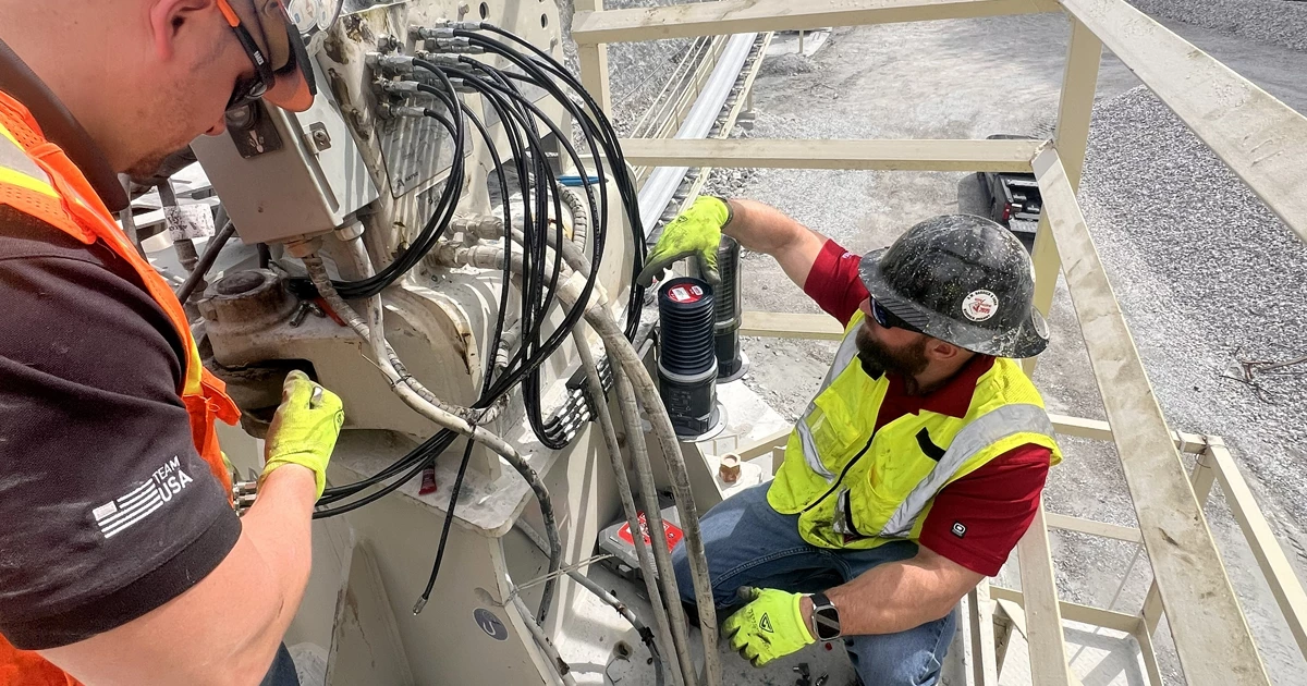 Technician reviewing lubrication data in an industrial facility