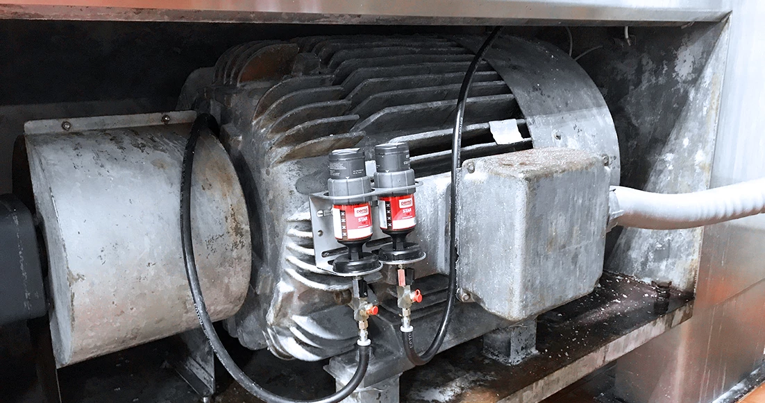 two perma STAR VARIO auto greasers on an industrial electric motor